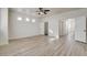 Bright main bedroom with light wood flooring, fan, and doors leading to the closet and bathroom at 3932 Maldive Isle Ct, Las Vegas, NV 89129