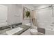 Bathroom with granite countertop, decorative mirror, and shower-tub combo at 452 Triple Falls St, Indian Springs, NV 89018