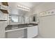 Bathroom vanity area featuring a large mirror, granite counters, cabinets and decor at 452 Triple Falls St, Indian Springs, NV 89018