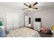 Bedroom featuring a ceiling fan, TV, and double-door closet at 452 Triple Falls St, Indian Springs, NV 89018