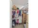 Walk-in closet with clothes, a chair, boxes and an overhead shelf at 452 Triple Falls St, Indian Springs, NV 89018