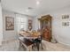 Comfortable dining area with rustic table, wooden bench, and an ornate hutch, perfect for Gathering meals at 452 Triple Falls St, Indian Springs, NV 89018