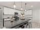 Modern kitchen showcasing granite countertops, stainless steel appliances, subway tile backsplash, and a breakfast bar at 452 Triple Falls St, Indian Springs, NV 89018