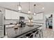 Bright kitchen featuring granite countertops, stainless steel appliances, and pendant lighting over a breakfast bar island at 452 Triple Falls St, Indian Springs, NV 89018