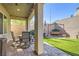 Inviting backyard patio with brick pavers, comfortable seating, and lush artificial grass at 4813 Stony Hill St, North Las Vegas, NV 89031