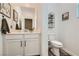 Half bathroom with white vanity, modern fixtures, and decorative wall art at 4813 Stony Hill St, North Las Vegas, NV 89031