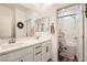 Bright bathroom features a double vanity, neutral color palette, and a tub with shower at 4813 Stony Hill St, North Las Vegas, NV 89031