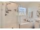 Clean bathroom features a glass enclosed shower, soaking tub, and neutral color palette at 4813 Stony Hill St, North Las Vegas, NV 89031