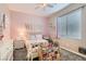 Cute bedroom features a pink accent wall, playful decor and comfortable carpet at 4813 Stony Hill St, North Las Vegas, NV 89031