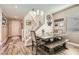 Dining room with a rustic-style table, bench seating, and a staircase in the background at 4813 Stony Hill St, North Las Vegas, NV 89031