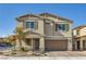 Two-story home with a neutral-colored exterior, brown shutters, a two-car garage, and desert landscaping at 4813 Stony Hill St, North Las Vegas, NV 89031