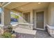 Covered front porch with brick pavers, decorative column bases, and a dark-colored front door at 4813 Stony Hill St, North Las Vegas, NV 89031