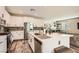 Contemporary kitchen with a central island, stainless steel appliances, and an adjacent dining area at 4813 Stony Hill St, North Las Vegas, NV 89031