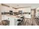 Well-lit kitchen featuring white cabinetry, stainless steel appliances, and an island with bar stool seating at 4813 Stony Hill St, North Las Vegas, NV 89031