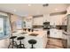 Modern kitchen with white cabinets, a large island, stainless steel appliances, and a sliding door at 4813 Stony Hill St, North Las Vegas, NV 89031