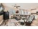 Cozy living room with a large sectional sofa, wood floors, and an adjacent kitchen area at 4813 Stony Hill St, North Las Vegas, NV 89031