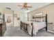 Relaxing main bedroom boasts a ceiling fan, neutral walls, and comfortable bed with wood frame at 4813 Stony Hill St, North Las Vegas, NV 89031