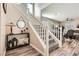 Charming home staircase featuring wood floors, white banister, and decor for a welcoming ambiance at 4813 Stony Hill St, North Las Vegas, NV 89031