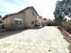 Spacious backyard featuring brick pavers, desert landscaping, covered patio and house exterior at 5255 Autumn Sky Rd, Las Vegas, NV 89118