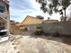 Backyard featuring dirt and desert landscaping, block wall and adjacent home at 5255 Autumn Sky Rd, Las Vegas, NV 89118