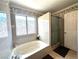 The bathroom features a tub and a tiled shower behind a glass door at 5255 Autumn Sky Rd, Las Vegas, NV 89118