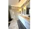 Bathroom featuring double sinks, white cabinets, and decorative tiling above the vanities at 5255 Autumn Sky Rd, Las Vegas, NV 89118