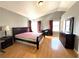 Bright bedroom featuring hardwood floors, ample natural light, and dark wood furniture at 5255 Autumn Sky Rd, Las Vegas, NV 89118