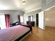 Bright bedroom featuring hardwood floors, ample natural light, and dark wood furniture at 5255 Autumn Sky Rd, Las Vegas, NV 89118