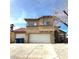 Two-story home with three-car garage and desert landscaping at 5255 Autumn Sky Rd, Las Vegas, NV 89118