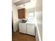 A bright laundry room features a new washer, dryer and ample storage space at 5255 Autumn Sky Rd, Las Vegas, NV 89118