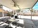 Covered patio with ceiling fan, grill, outdoor seating and paver flooring at 5255 Autumn Sky Rd, Las Vegas, NV 89118