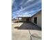 A backyard with a covered patio, concrete area, and a sliding glass door at 5312 W Oakey Blvd, Las Vegas, NV 89146