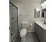 A well-lit bathroom features a shower with glass doors and a gray vanity with a sink at 5312 W Oakey Blvd, Las Vegas, NV 89146