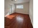 Well-lit bedroom featuring wood floors, closet, and a large window at 5312 W Oakey Blvd, Las Vegas, NV 89146