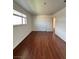 A simple bedroom features neutral walls, wood floors, and a window for natural light at 5312 W Oakey Blvd, Las Vegas, NV 89146