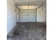 Spacious empty garage with a white door and concrete floor at 5312 W Oakey Blvd, Las Vegas, NV 89146