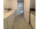 A laundry room with a washer, dryer, white cabinets, and tiled floors at 5312 W Oakey Blvd, Las Vegas, NV 89146