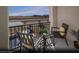 Relaxing covered balcony with comfortable seating and a small table, perfect for outdoor enjoyment at 5725 Crenellated St # Lot 69, Las Vegas, NV 89148