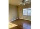 Cozy bedroom featuring wood floors, neutral walls, a ceiling fan, and a window for natural light at 5758 Yellowcrest Ct, Las Vegas, NV 89113