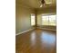 Bedroom featuring hardwood floors, neutral walls, base molding, and two windows for ample sunlight at 5758 Yellowcrest Ct, Las Vegas, NV 89113