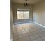 Dining room with tile flooring, neutral walls, a chandelier, and a window for natural light at 5758 Yellowcrest Ct, Las Vegas, NV 89113