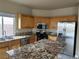 Bright kitchen with wood cabinets, stainless steel appliances, and a granite countertop island at 5758 Yellowcrest Ct, Las Vegas, NV 89113