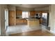 Spacious kitchen featuring wood cabinets, stainless steel appliances, and a large granite island at 5758 Yellowcrest Ct, Las Vegas, NV 89113