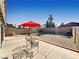 Spacious backyard with a patio area, gravel landscaping, and block wall fencing at 592 Grimsby Ave, Henderson, NV 89014