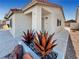 Charming home featuring desert landscaping, including succulent planters and rock features at 592 Grimsby Ave, Henderson, NV 89014