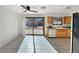 Bright kitchen features wood cabinets, white appliances, and sliding glass doors to the backyard at 592 Grimsby Ave, Henderson, NV 89014