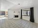 Inviting living room with tile floors, a cozy fireplace, and sliding glass doors to the outside at 592 Grimsby Ave, Henderson, NV 89014