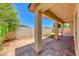 Outdoor patio featuring stone columns, a shaded area, and a well-manicured backyard at 5952 Long Bay St, Las Vegas, NV 89148