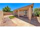 Relaxing backyard with a covered patio, lush greenery, and a mix of stone and brickwork at 5952 Long Bay St, Las Vegas, NV 89148