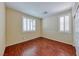 Bedroom with wood floors, white trim, and two windows providing natural light at 5952 Long Bay St, Las Vegas, NV 89148